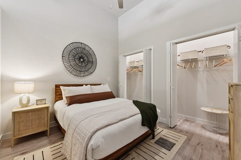 a bedroom with a bed and a closet with a shower